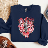 a blue sweatshirt with a heart on it next to a pair of shoes