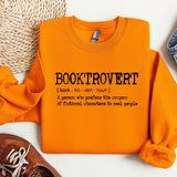 a pair of shoes and an orange shirt on a white surface