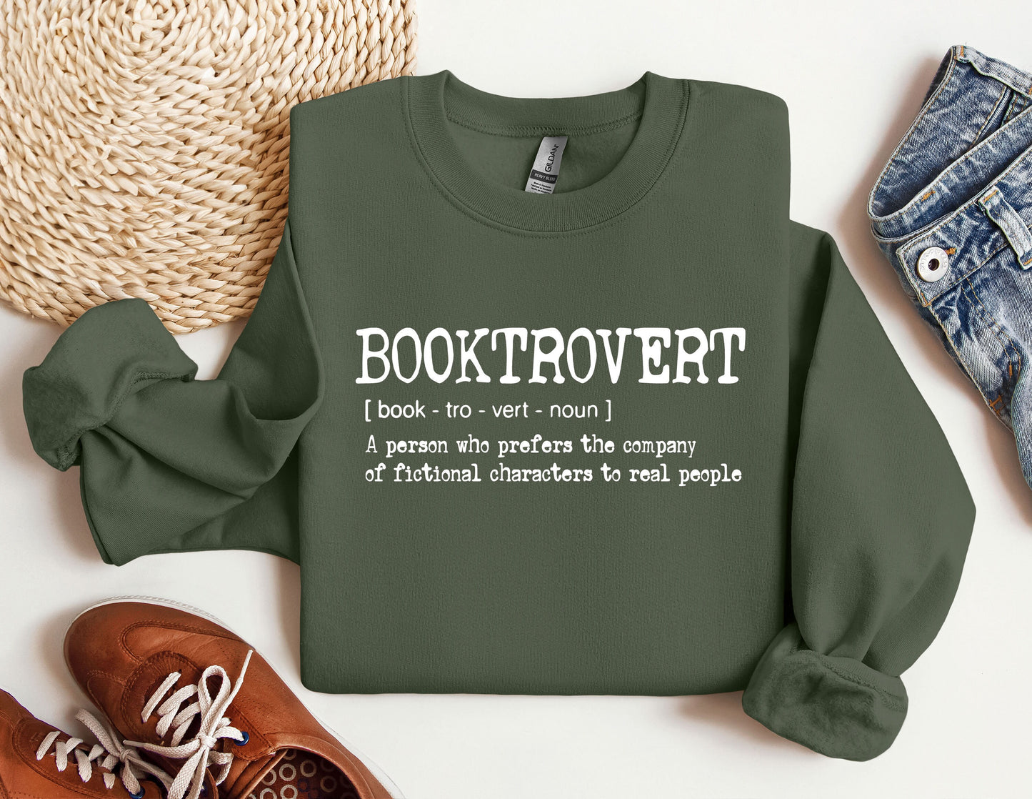 a green sweatshirt that says booktrover next to a pair of shoes