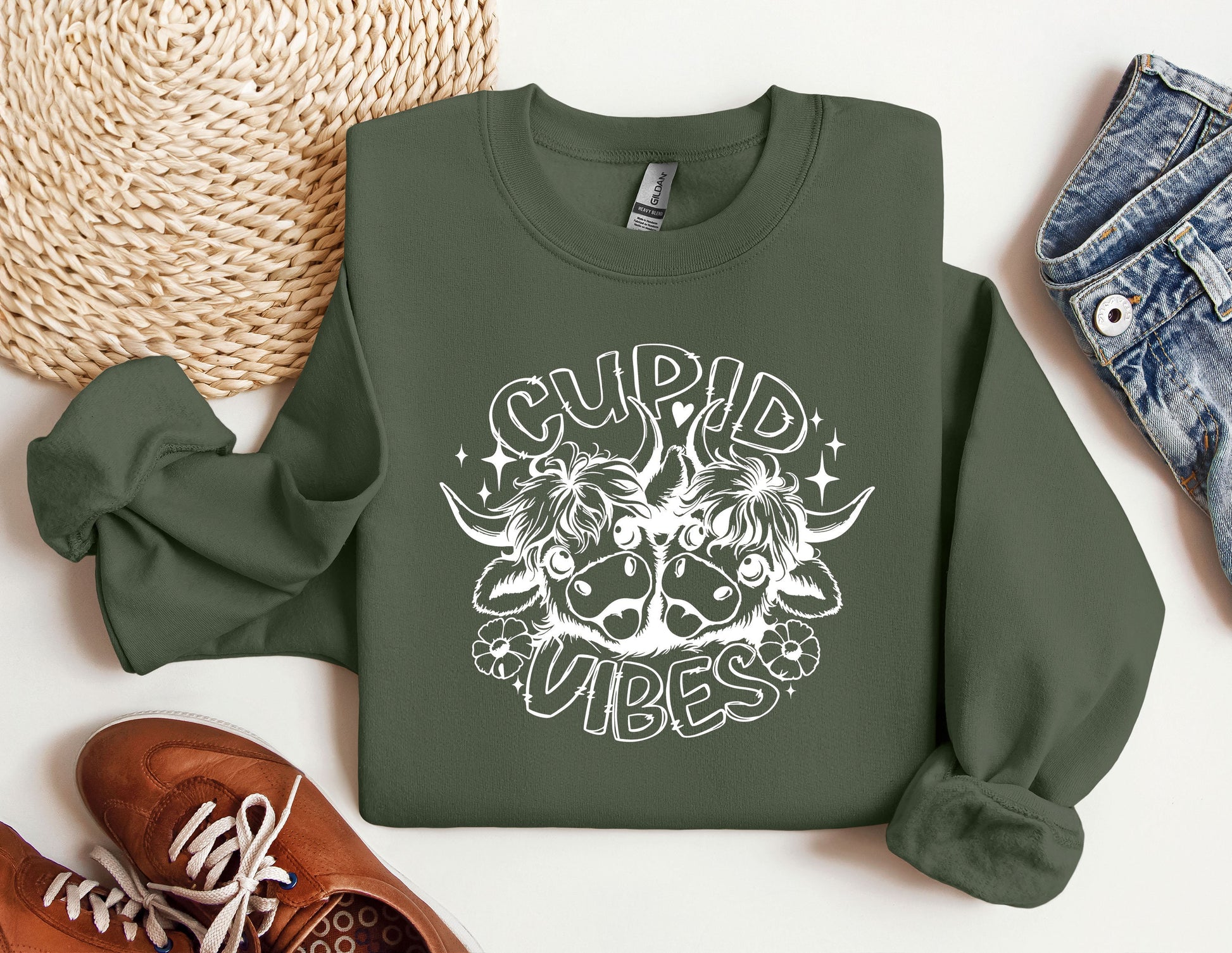 a green sweatshirt with a white graphic of a demon on it