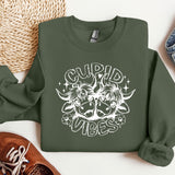 a green sweatshirt with a white graphic of a demon on it