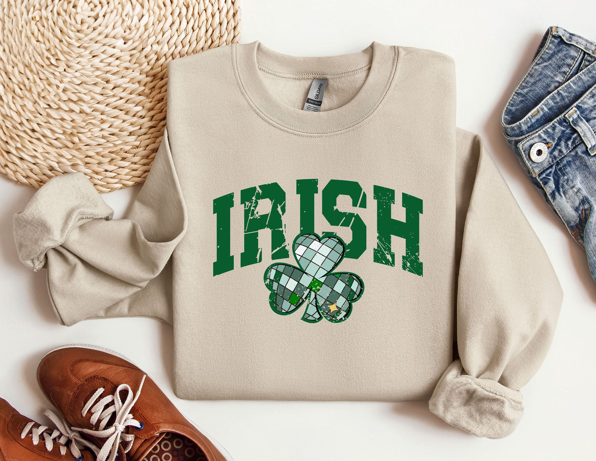 a sweater with a shamrock on it next to a pair of shoes