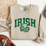 a sweater with a shamrock on it next to a pair of shoes