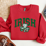a red sweatshirt with a shamrock on it
