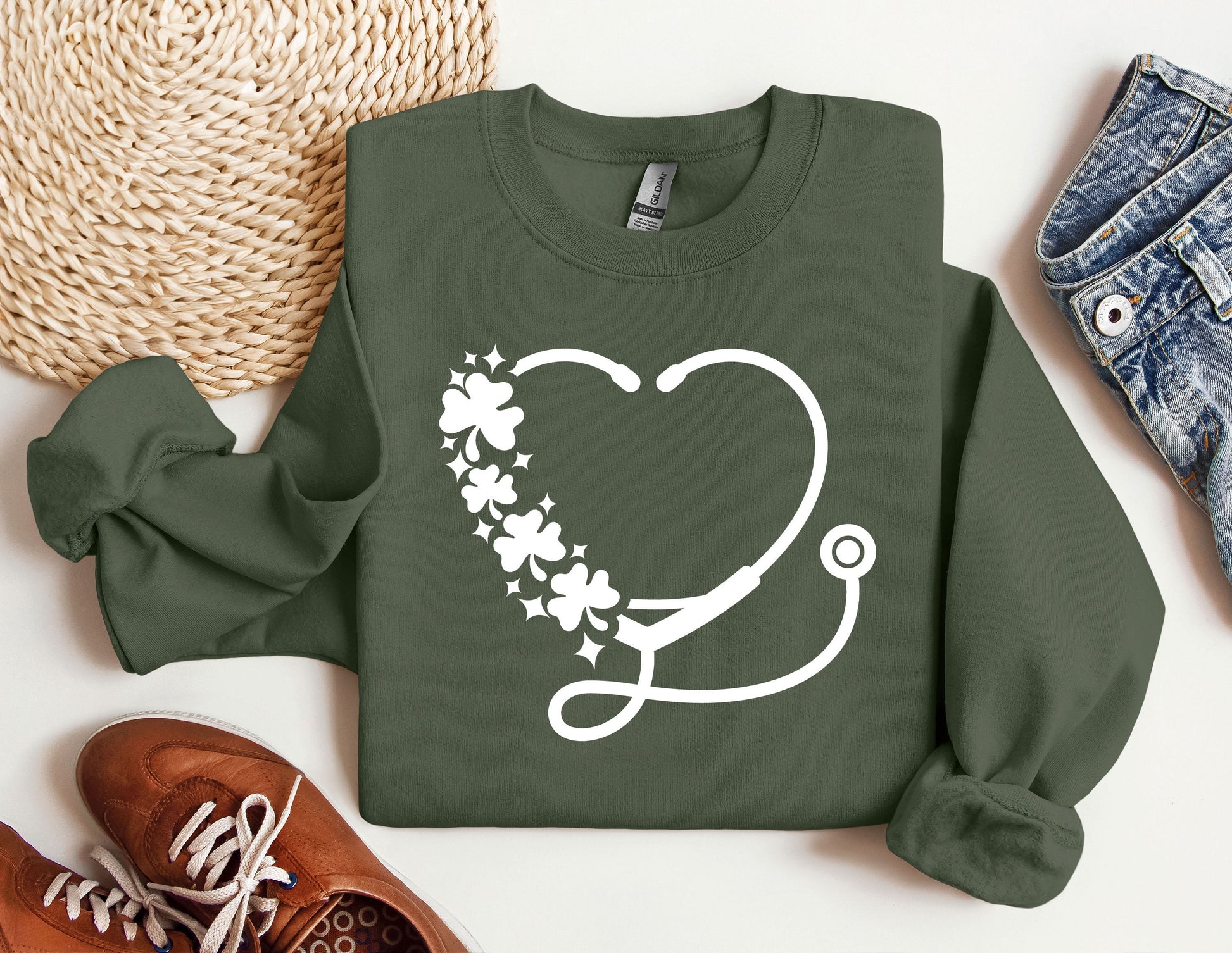 a green sweatshirt with a stethoscope and flowers on it