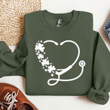 a green sweatshirt with a stethoscope and flowers on it