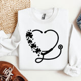 a sweater with a stethoscope and flowers on it