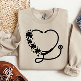 a sweater with a stethoscope and flowers on it