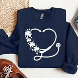 a sweater with a stethoscope and flowers on it