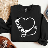 a sweater with a stethoscope and flowers on it