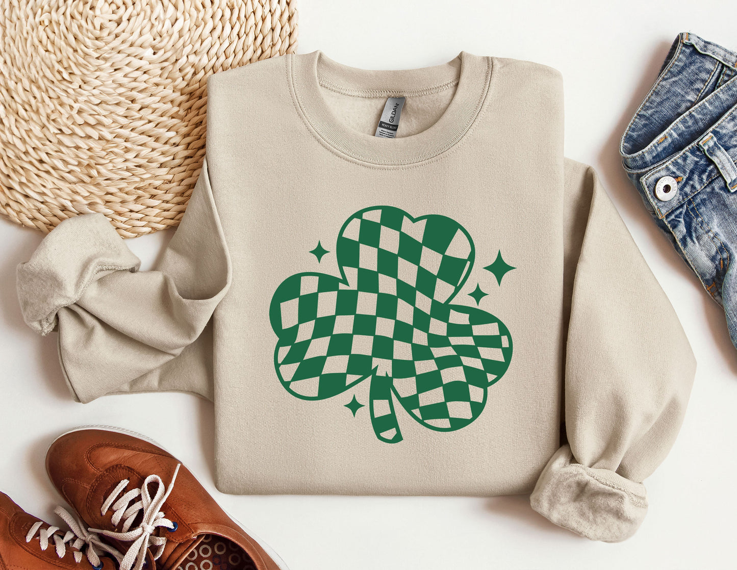 a sweater with a shamrock on it next to a pair of shoes