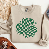 a sweater with a shamrock on it next to a pair of shoes