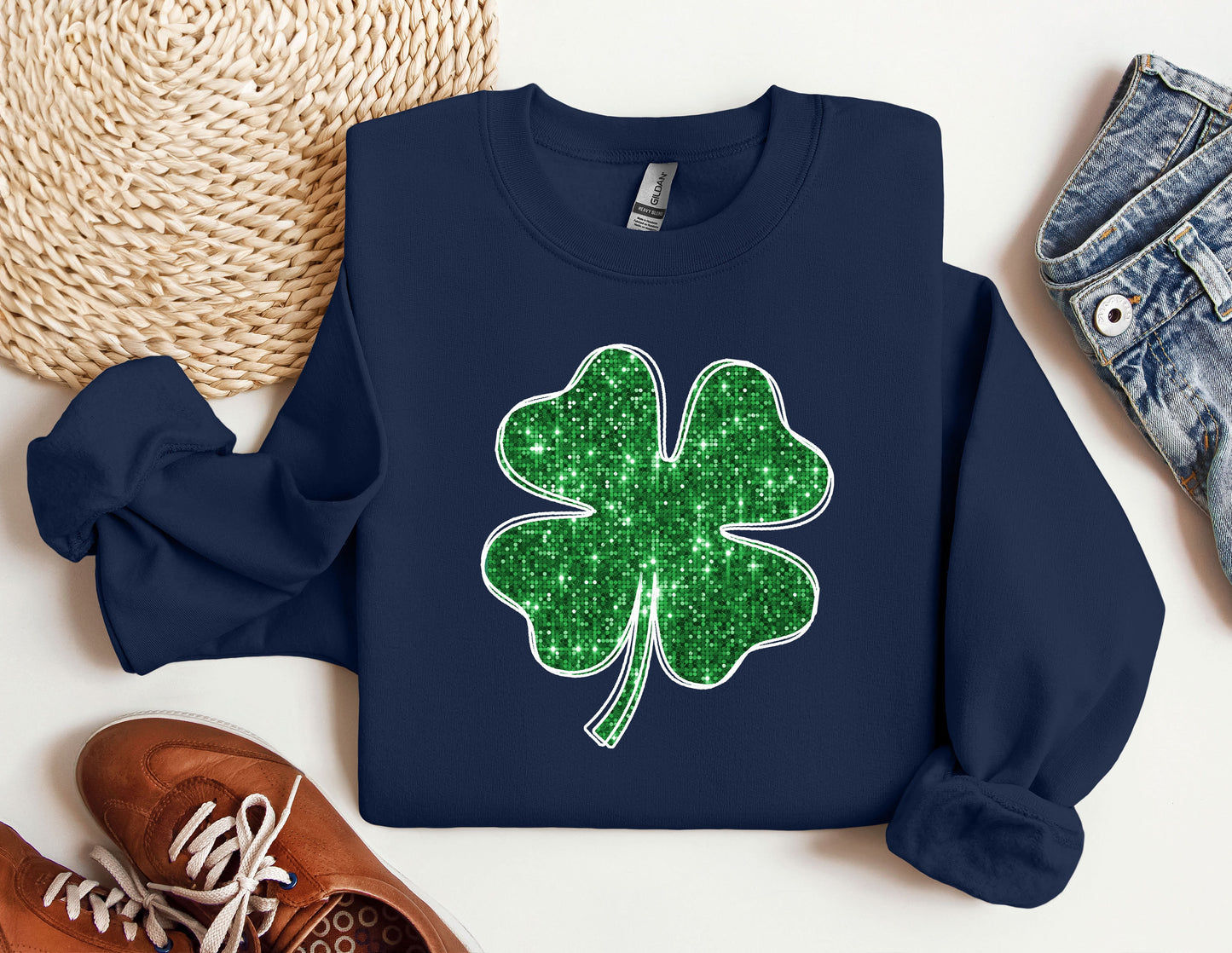 a blue sweater with a green shamrock on it