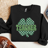 a black shirt with a green clover on it