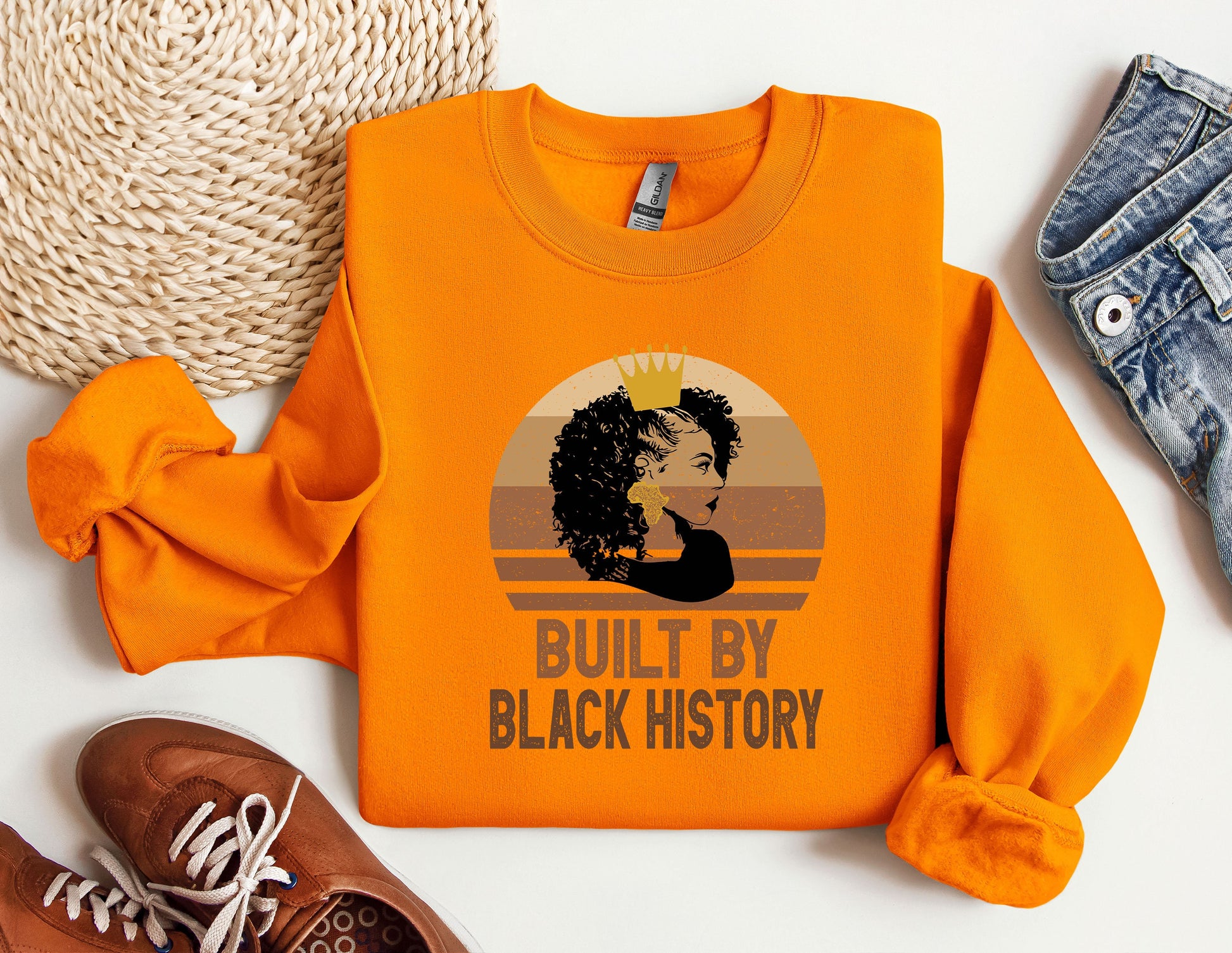 an orange sweatshirt with a picture of a woman&#39;s face on it