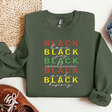 a green sweatshirt with the words black on it