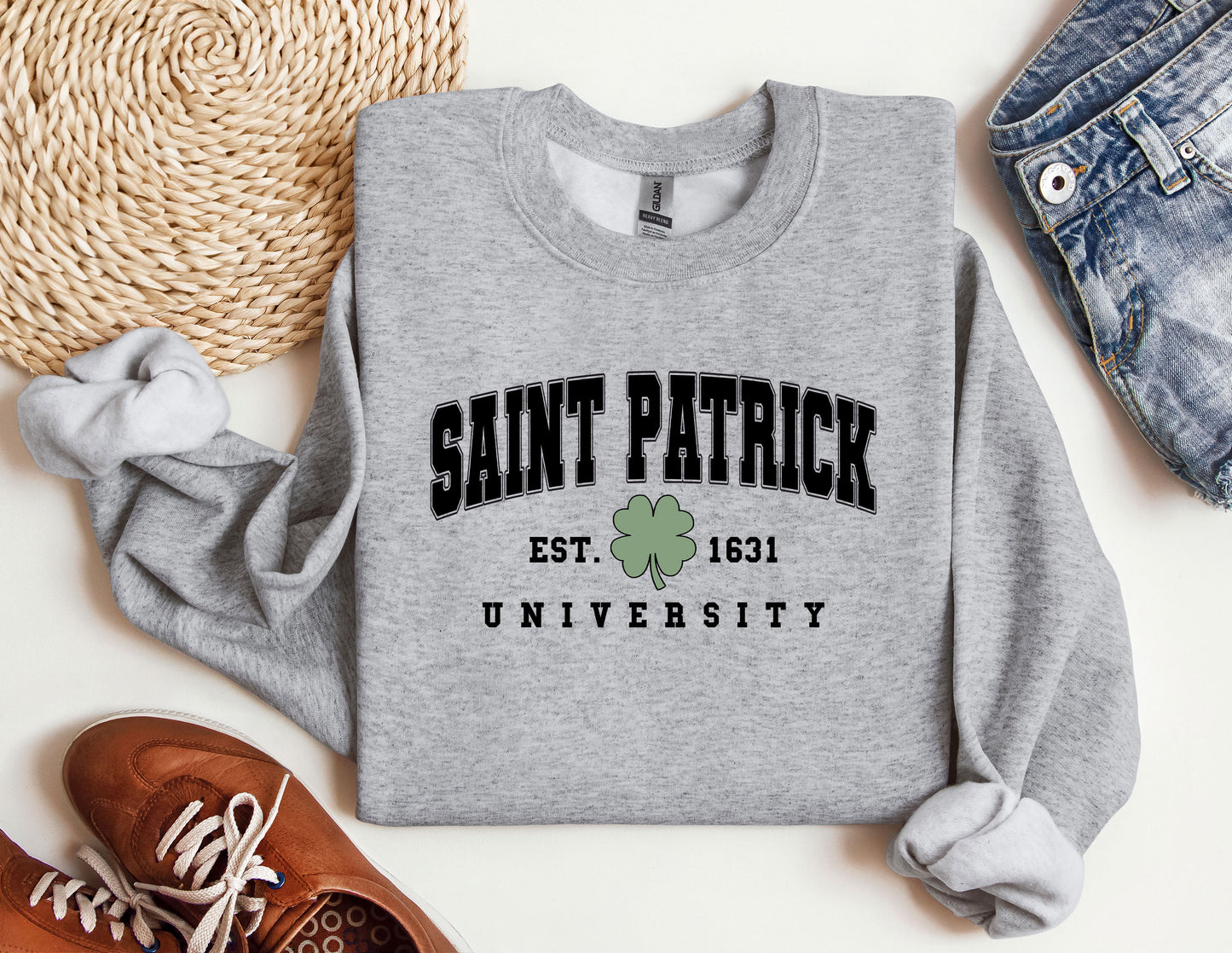 a sweatshirt with a shamrock on it next to a pair of shoes