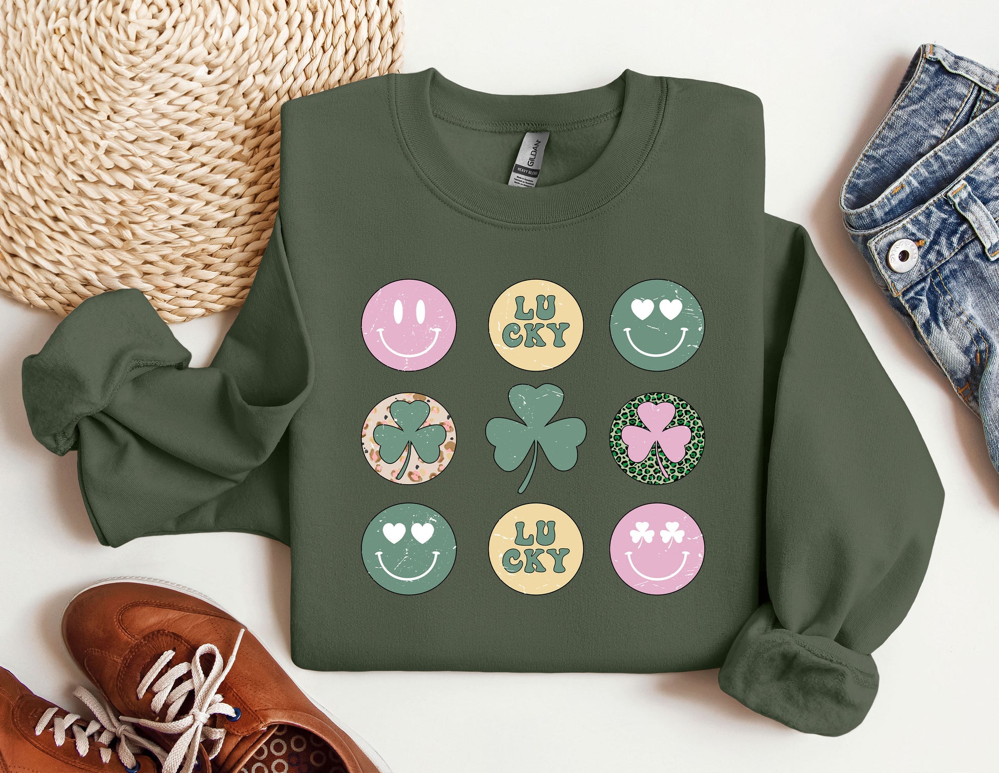 a green sweatshirt with shamrocks and smiley faces on it