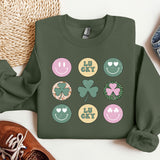 a green sweatshirt with shamrocks and smiley faces on it