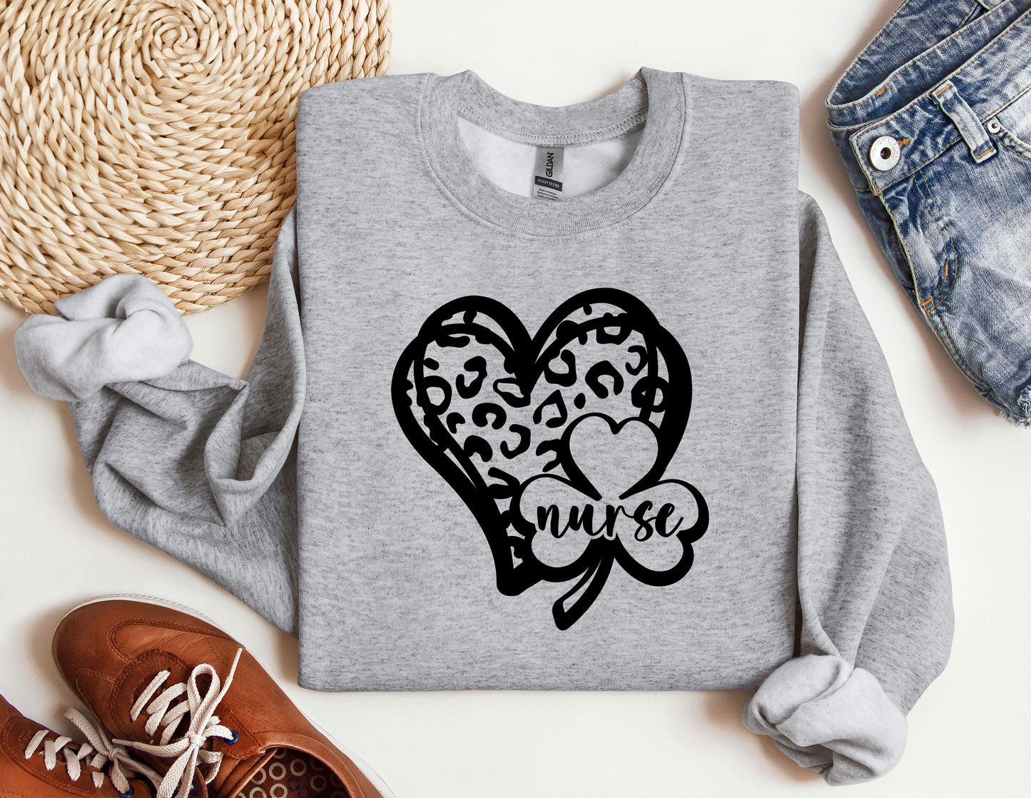 a sweater with a heart and a clover on it