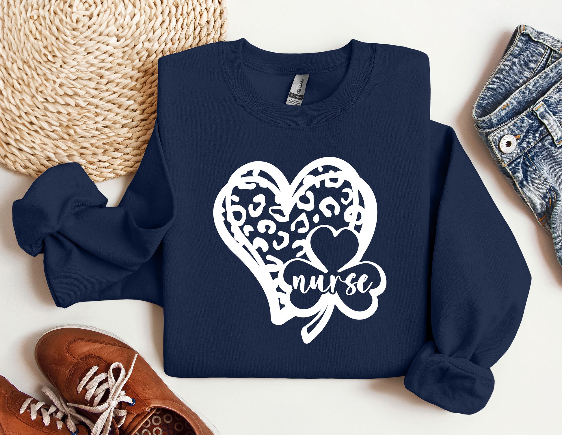 a blue sweatshirt with a heart and two clovers on it