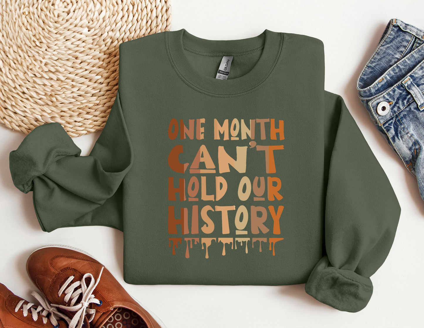 a green sweatshirt with the words one month can&#39;t hold our history printed on