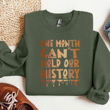 a green sweatshirt with the words one month can't hold our history printed on