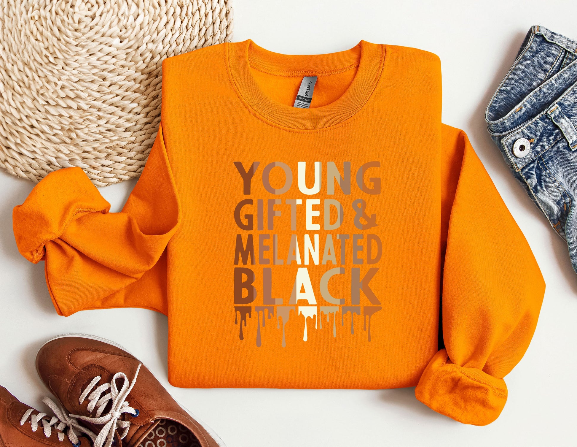 a pair of shoes and an orange shirt on a white surface
