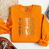 a pair of shoes and an orange shirt on a white surface