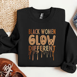 a black sweatshirt with the words black women glow different on it