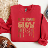 a red sweatshirt with the words black women glow different colors