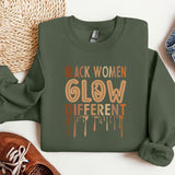 a green sweatshirt with the words black women glow different on it