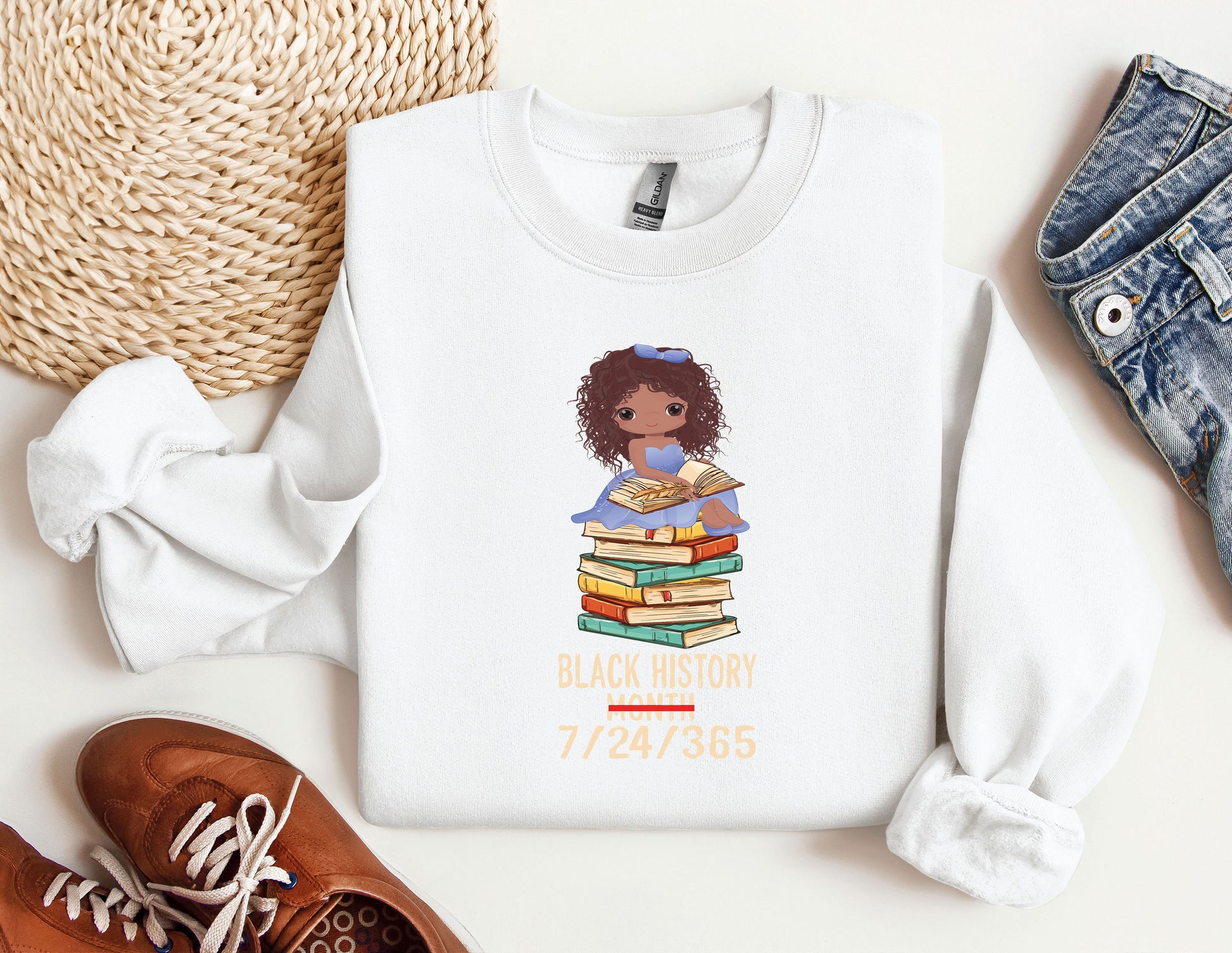 a white shirt with a black girl holding a stack of books