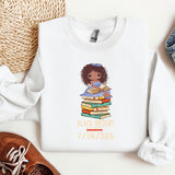 a white shirt with a black girl holding a stack of books