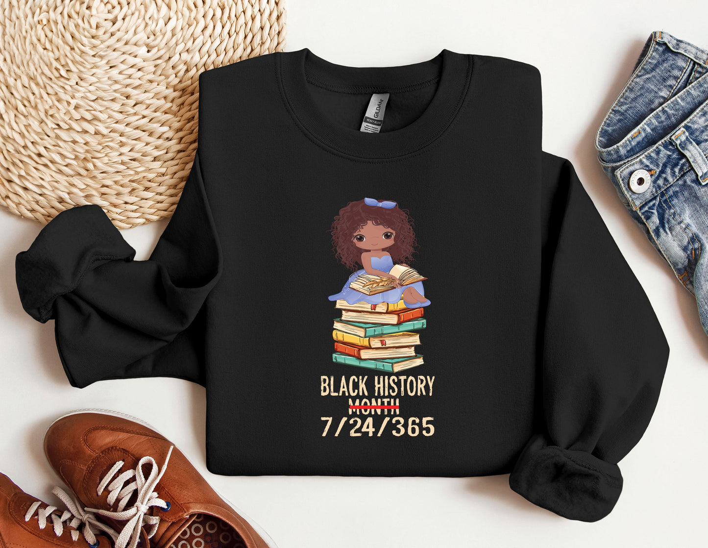 a black history month shirt with a black girl holding a stack of books