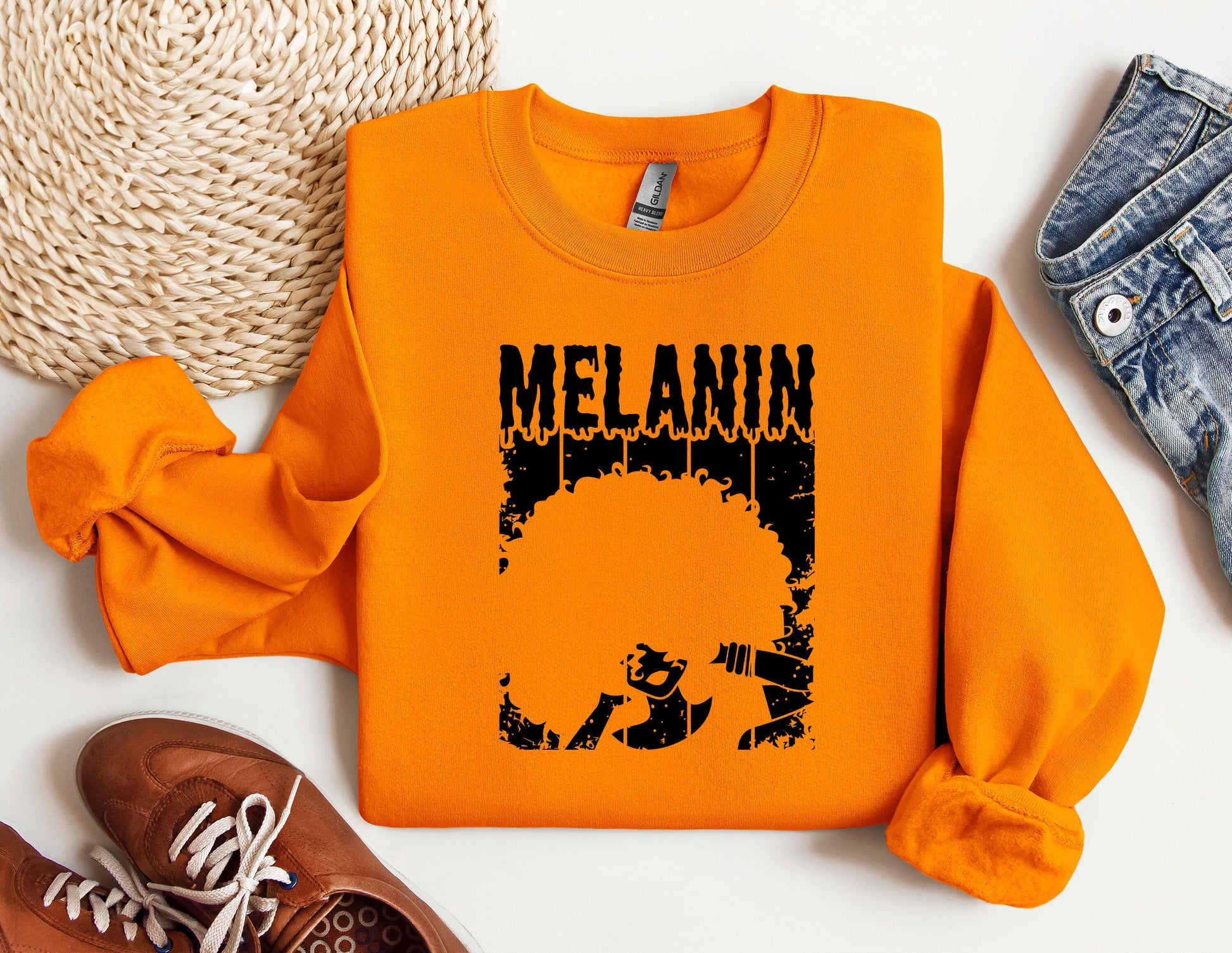 an orange sweatshirt with a picture of melanin on it