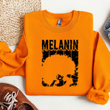an orange sweatshirt with a picture of melanin on it