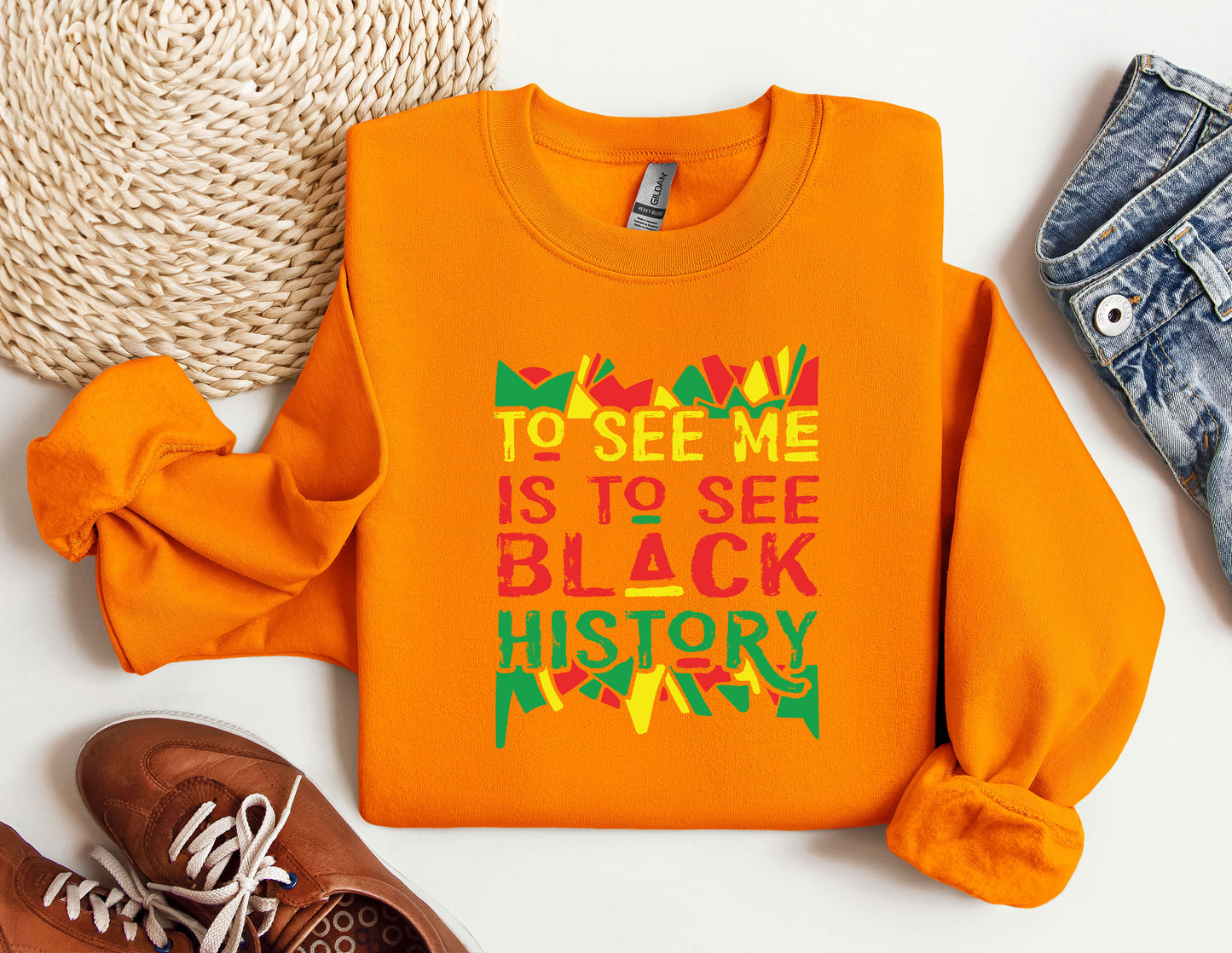 an orange shirt with the words to see me is to see a black history month