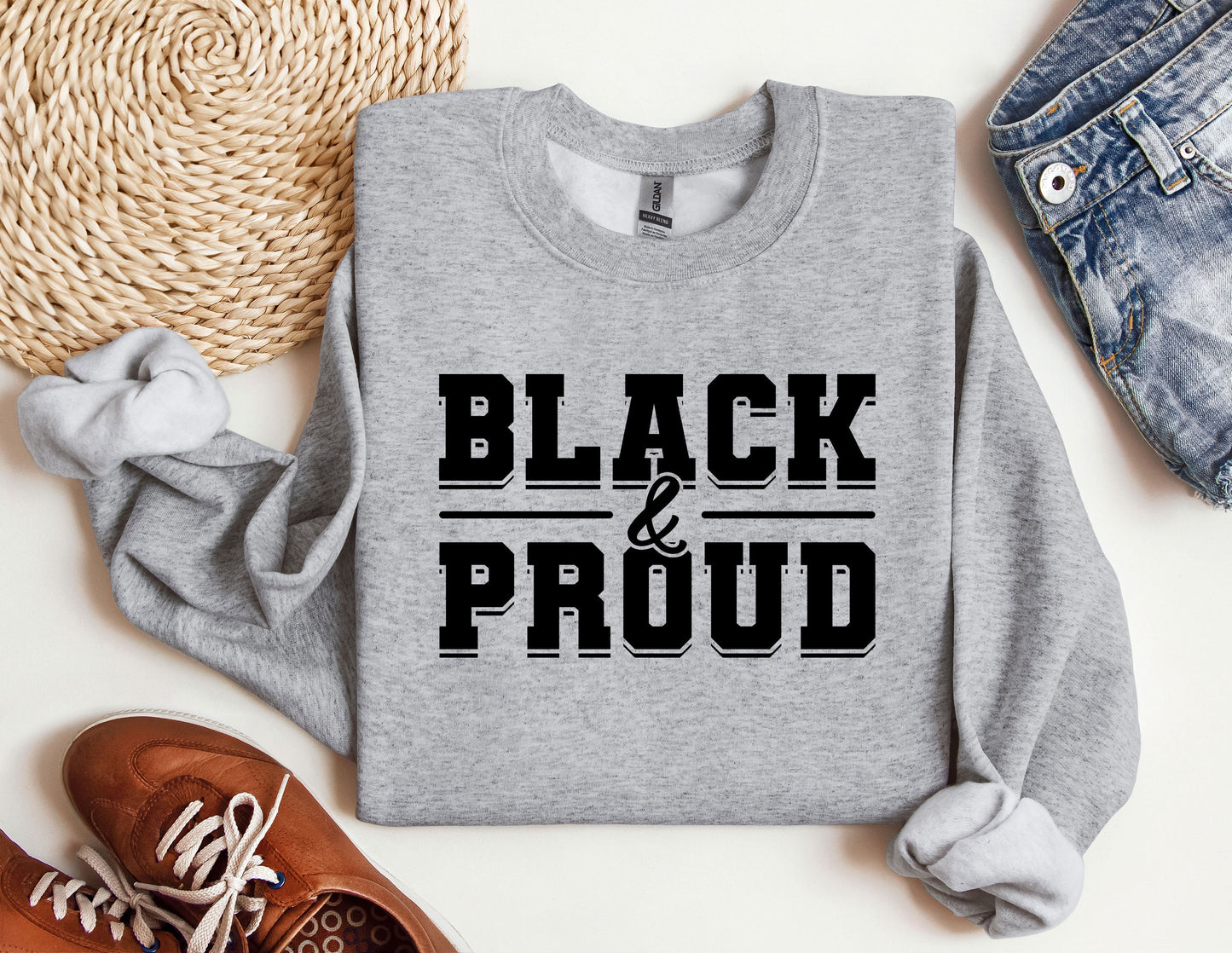 a sweater that says black and proud on it