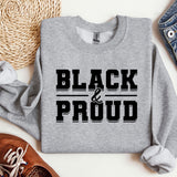 a sweater that says black and proud on it