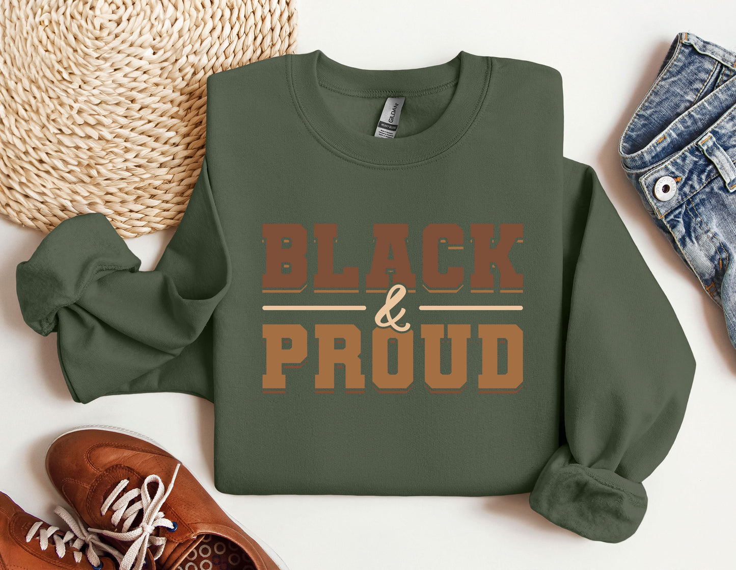 a green sweatshirt with the words black and proud printed on it