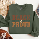 a green sweatshirt with the words black and proud printed on it