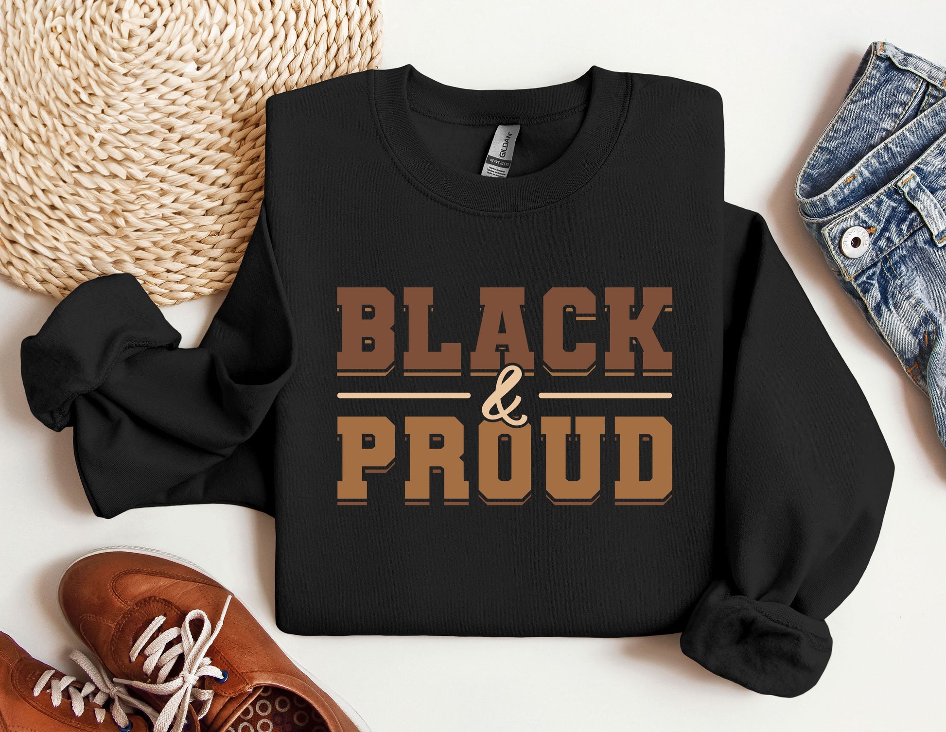 a black and proud shirt next to a pair of sneakers