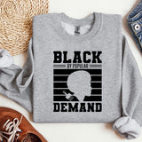 a gray sweatshirt with a picture of a man's face and the words black