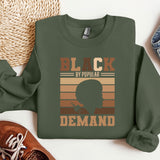a green sweatshirt with a picture of a man's head and the words black