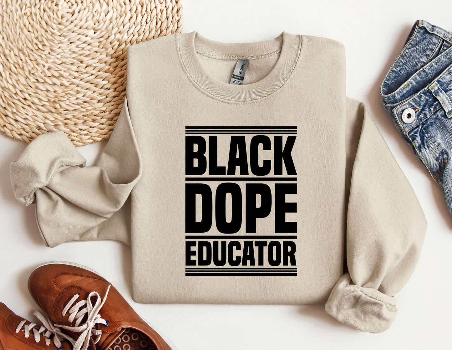 a sweater that says black dope educator next to a pair of shoes