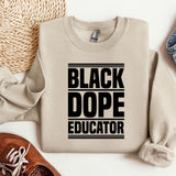 a sweater that says black dope educator next to a pair of shoes