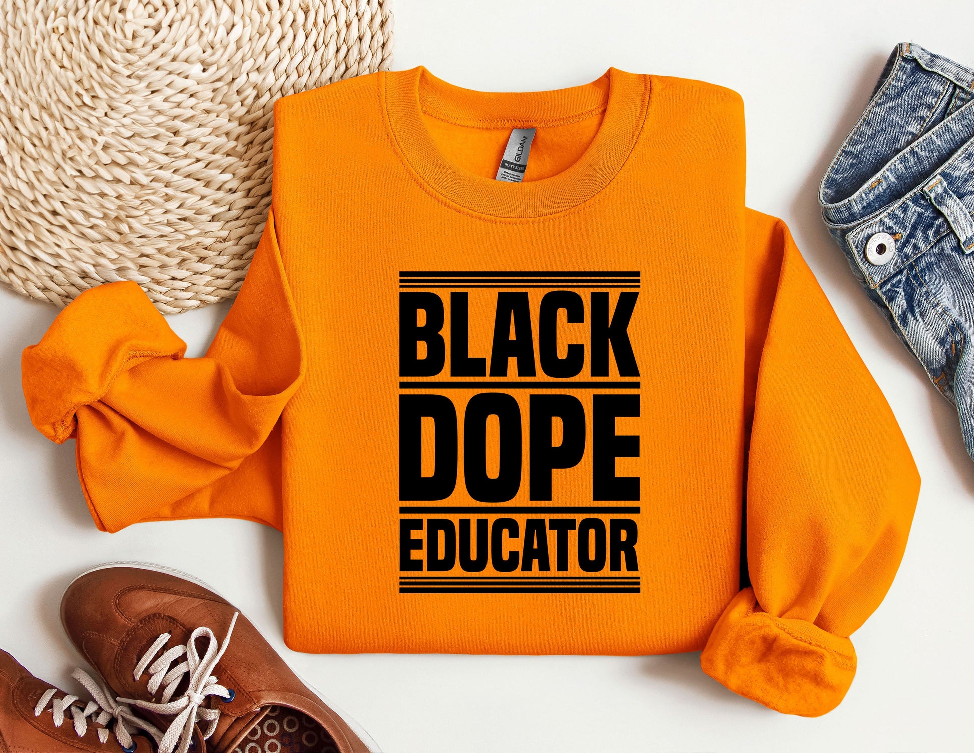 a black dope instructor shirt next to a pair of sneakers