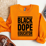 a black dope instructor shirt next to a pair of sneakers