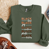 a green sweatshirt with the words black love, joy, experience and pride printed on